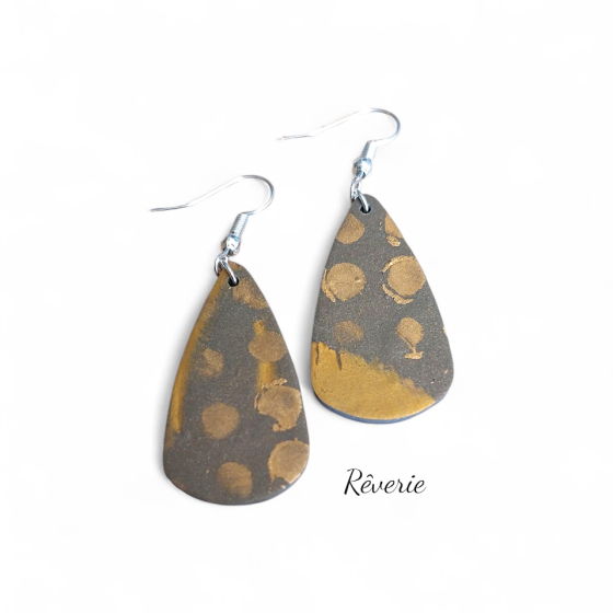 teardrop-shaped polymer clay earrings feature hand-applied gold dots over a deep charcoal base