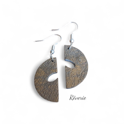 Bold form, earthy finish. These textured polymer clay earrings feature a split-circle design in deep bronze with organic surface detail.