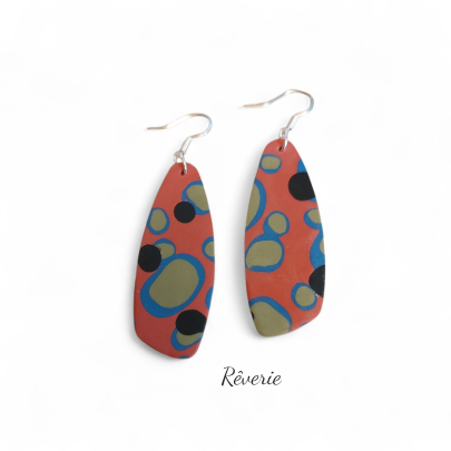 Playful, punchy, and full of personality. These coral polymer clay earrings feature abstract olive and black bubble motifs outlined in cobalt blue.