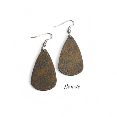Raw and refined. These earthy bronze-toned drop earrings feature organic texture with a subtle metallic sheen.